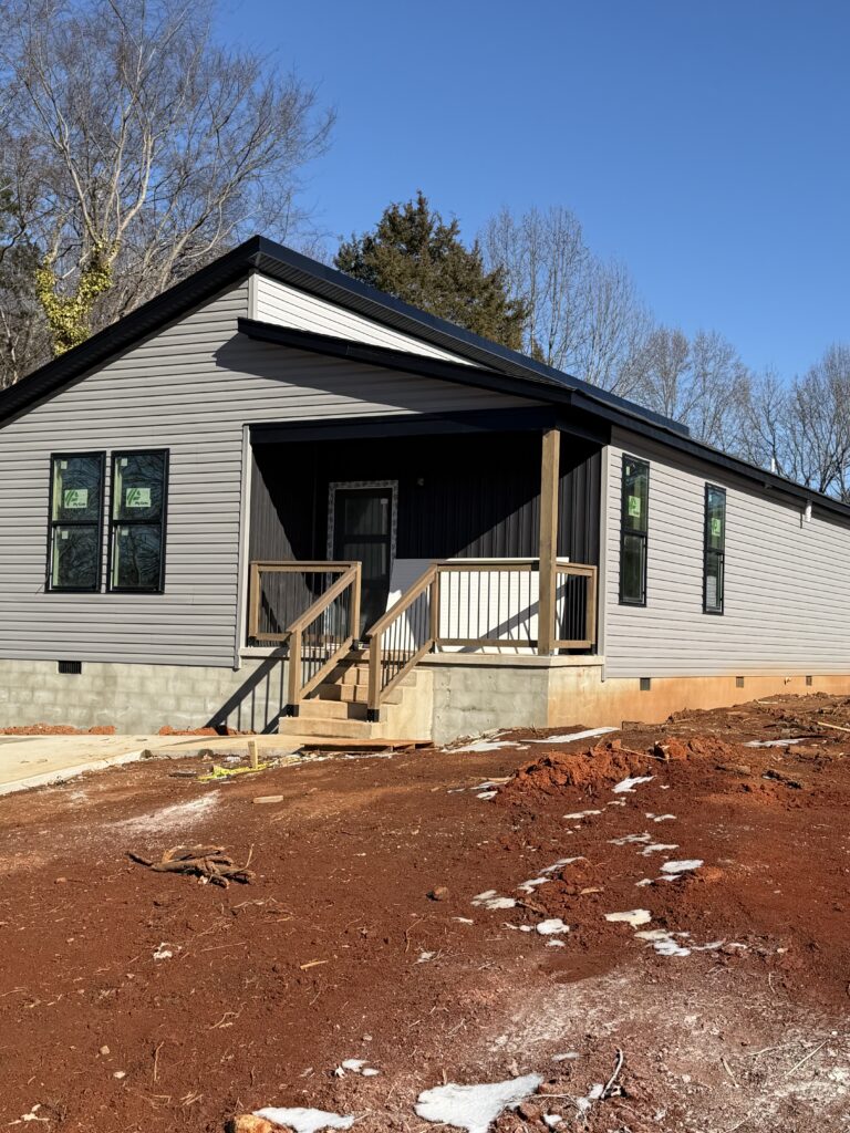 New single-story home with a covered front porch nearing completion