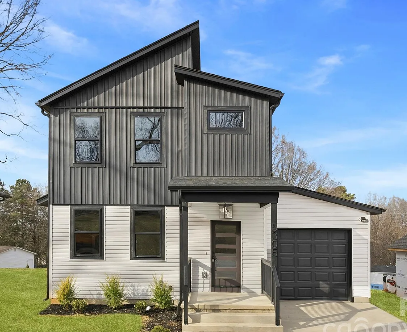 Modern two-story home with dark board-and-batten siding and white lap siding